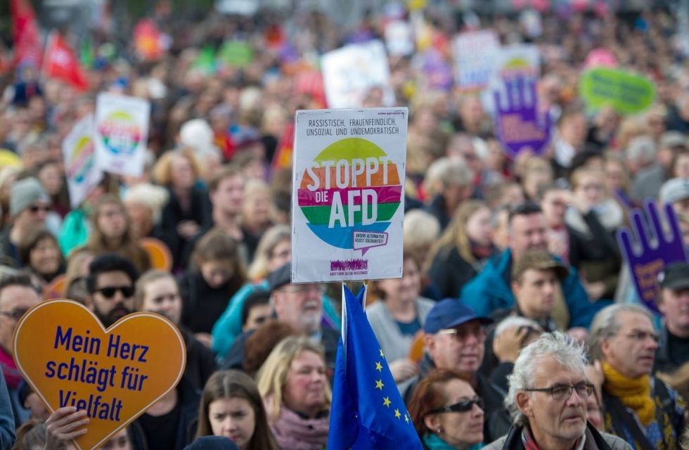 u200bA protestor holds up a sign reading "Stop the AFD"