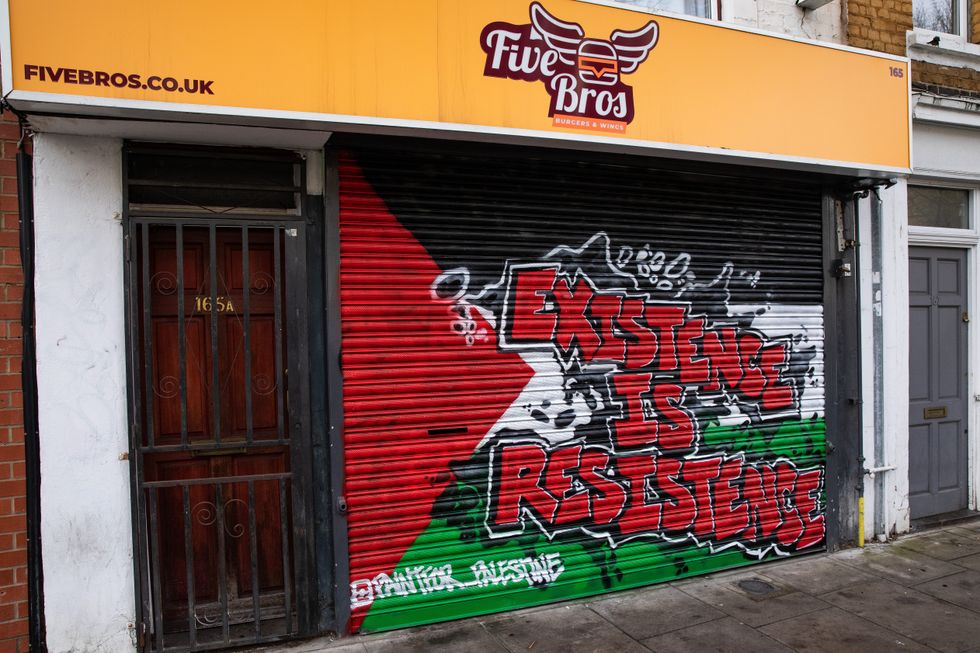 \u200bA shop blind in Tower Hamlets that says "existence is resistence"