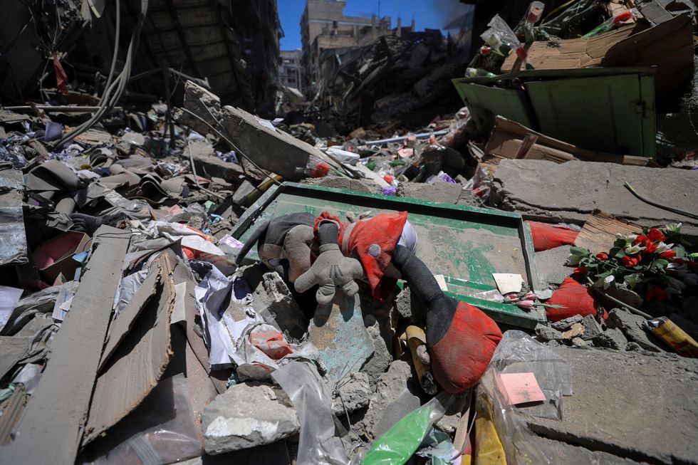 \u200bA stuffed toy lies amidst the rubble at the site of Israeli strikes on buildings at Gaza's Old City market, in Gaza City