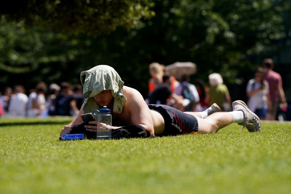 \u200bA sunbather enjoys the warm weather in London on Friday