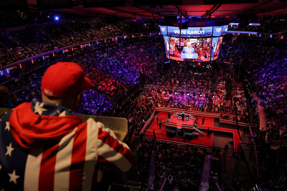 \u200bA supporter looks on as Republican presidential nominee and former U.S. President Donald Trump speaks on stage during a rally at Madison Square Garden, in New York