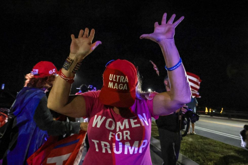 \u200bA supporter of Donald Trump gestures as they gather near his Mar-a-Lago resort in Palm Beach