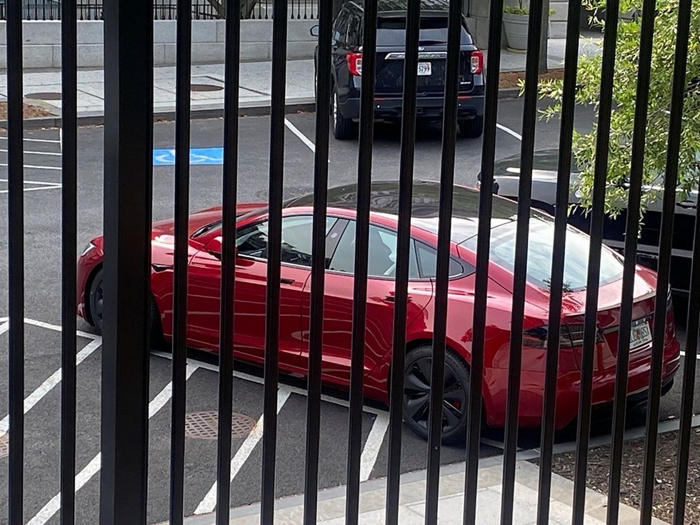 \u200bA Tesla vehicle is parked on West Executive Avenue near the White House
