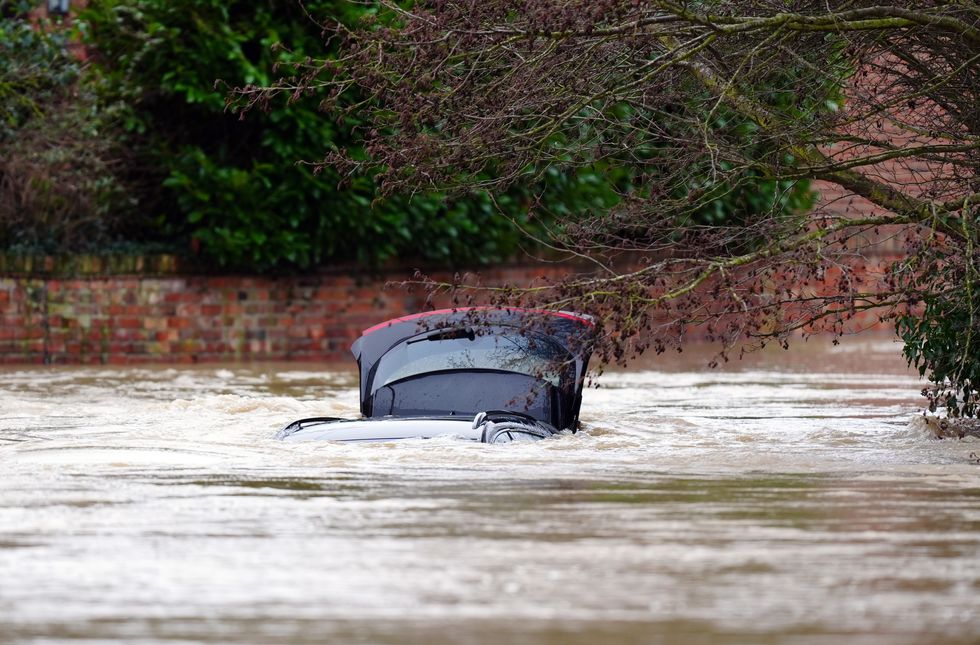 \u200bA vehicle is submerged under water near the River Devon