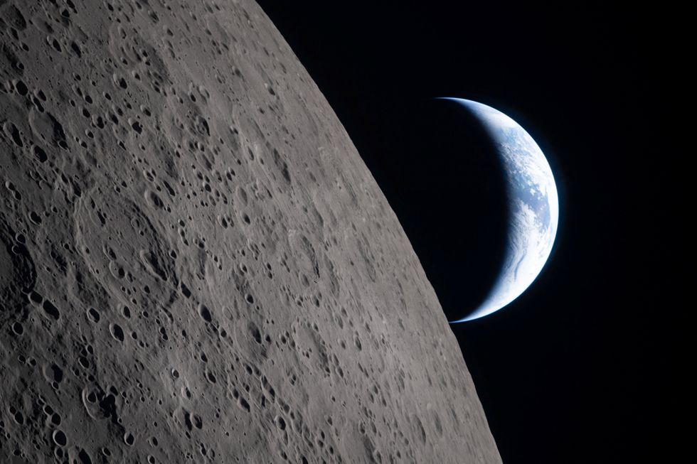 \u200bA view of Earth, partially hidden by the Moon, photographed through the Orion spacecraft window