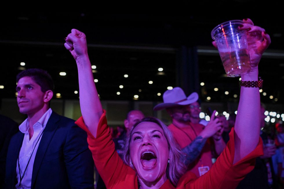 \u200bAn attendee reacts to early election results at Republican presidential nominee Trump