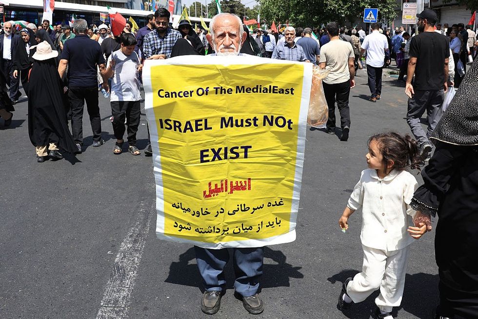 \u200bAn Iranian carries a placard during an anti-Israeli rally in Tehran