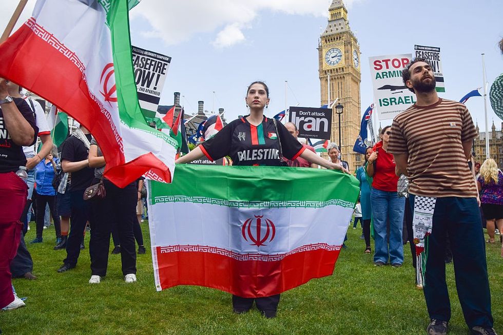 \u200bAn Iranian flag being held by a pro-Palestine supporter