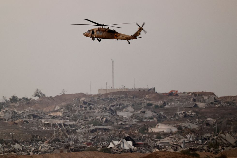 \u200bAn Israeli Blackhawk evacuation helicopter flies over Gaza, as seen from the Israeli side of the border