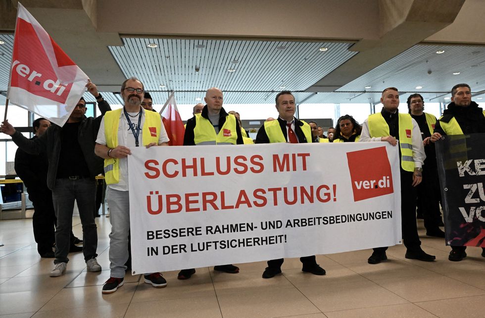 \u200bAviation security workers of Germany's Verdi union gather at Cologne-Bonn airport - The placard reads 'end pressure of work'