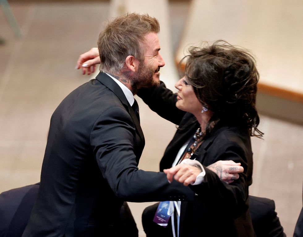 \u200bBeckham pictured embracing Eriksson's ex-partner Nancy Dell'Olio