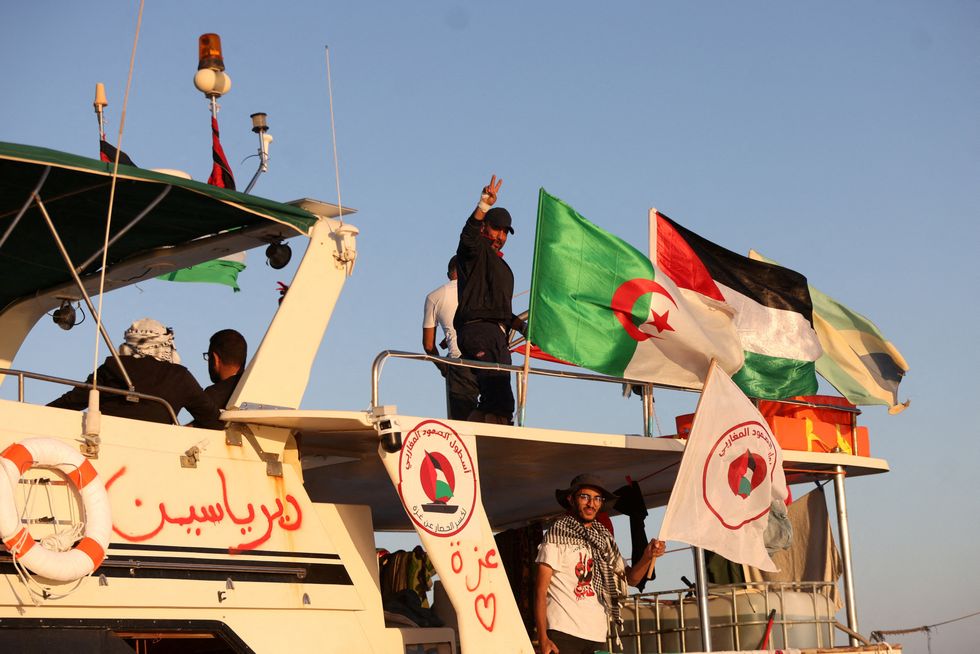 \u200bCrew interacts from aboard a boat, part of the Global Sumud Flotilla aiming to reach Gaza
