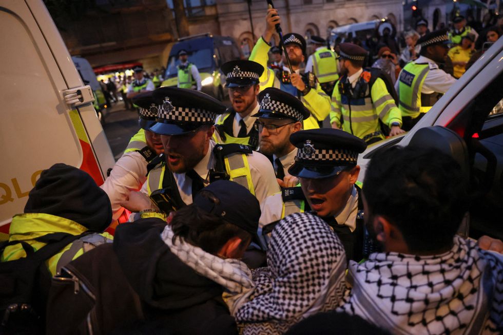 \u200bDemonstrators scuffle with police officers as they try to march along Whitehall
