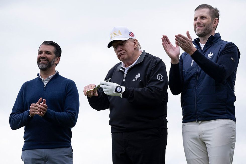\u200bDonald Jr and Eric Trump alongside their father