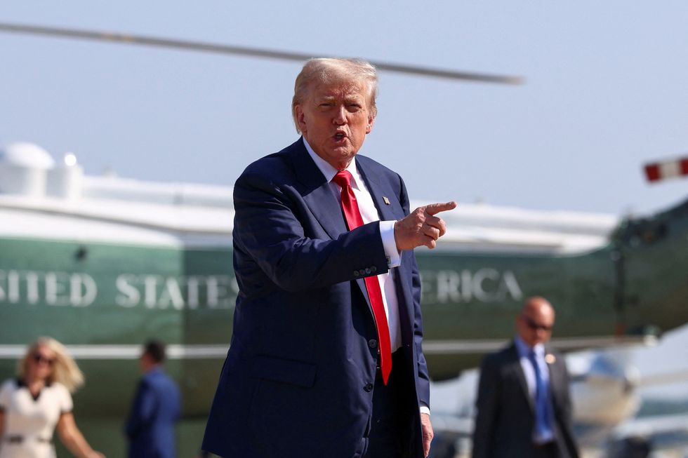 \u200bDonald Trump gestures after disembarking Marine One, as he departs for Scotland