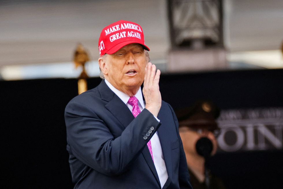 \u200bDonald Trump wears a 'Make America Great Again' (MAGA) hat as he attends the commencement ceremony at West Point Military Academy in West Point,