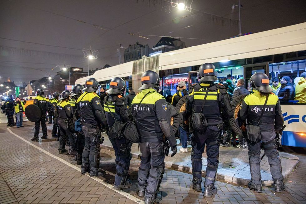 \u200bDutch mobile Police officers stand guard after several scuffles broke out in the city center following the UEFA Europa League match