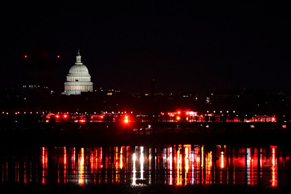 \u200bEmergency personnel work near the site of the crash in the Potomac
