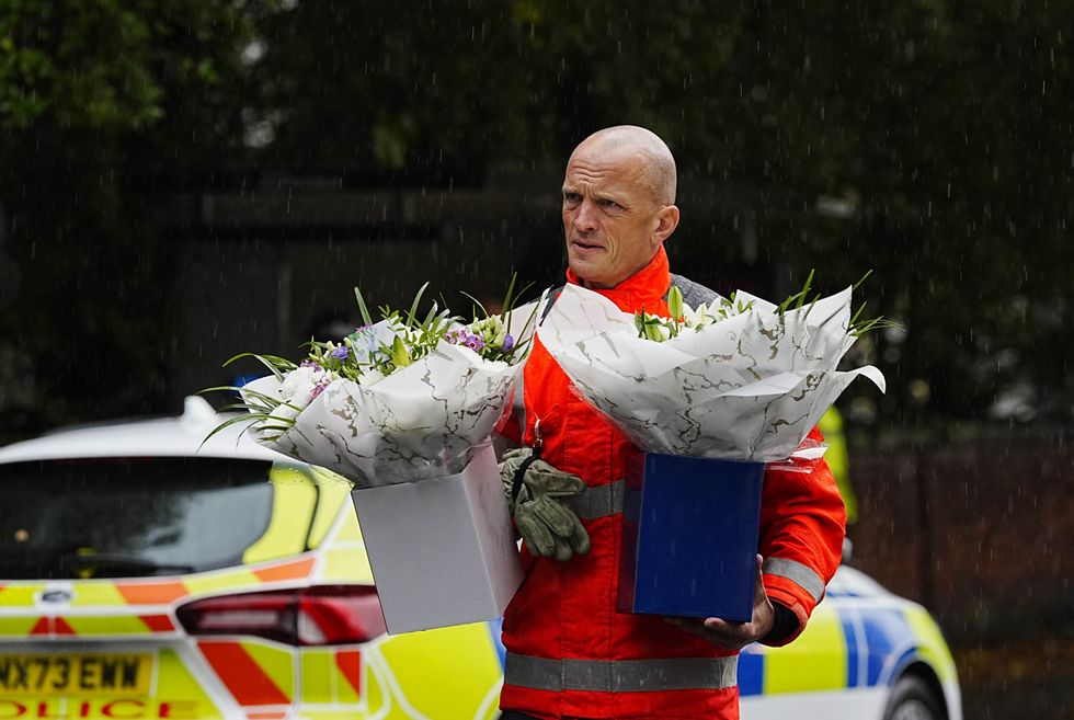 \u200bEmergency workers laid down flowers at the vigil