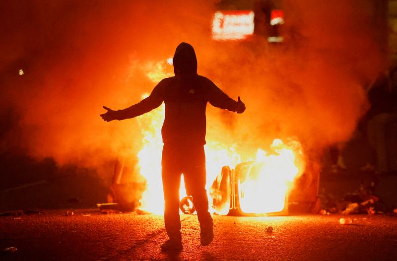 \u200bFire burns near a demonstrator as riots continue in Ballymena