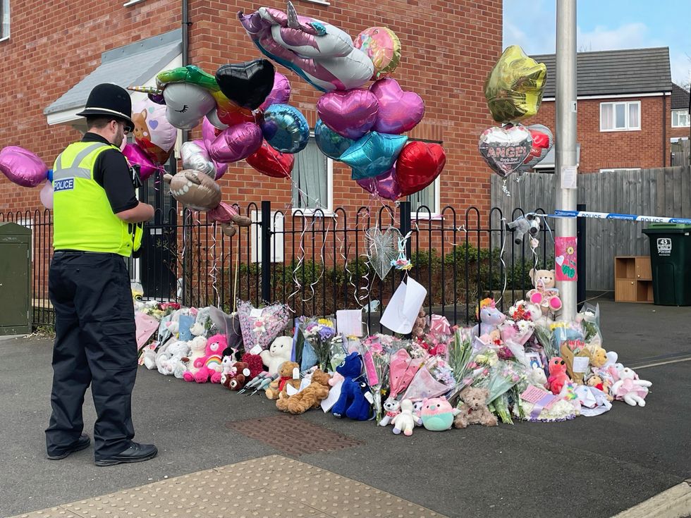 \u200bFloral tributes left at the entrance to Robin Close