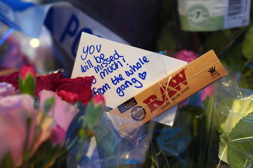 \u200bFloral tributes near Greenhill Street, close to Bedford bus station, following the stabbing of Thomas Taylor