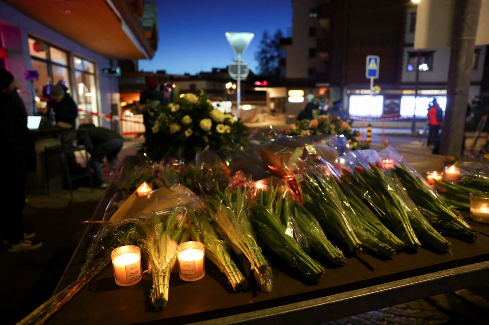 \u200bFlowers and candles are left near the "Le Constellation" bar,
