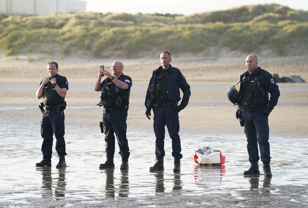\u200bFrench police officers watch a group of people