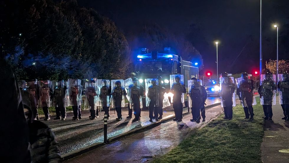 \u200bGardai officers block protesters outside
