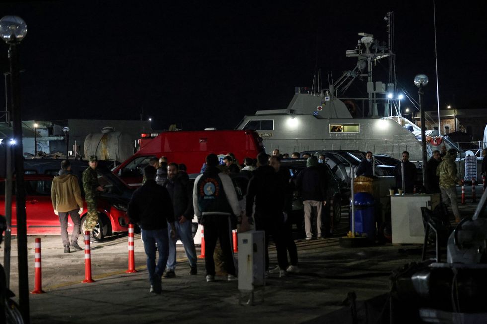 \u200bGreek emergency personnel wait to transfer bodies of dead migrants,