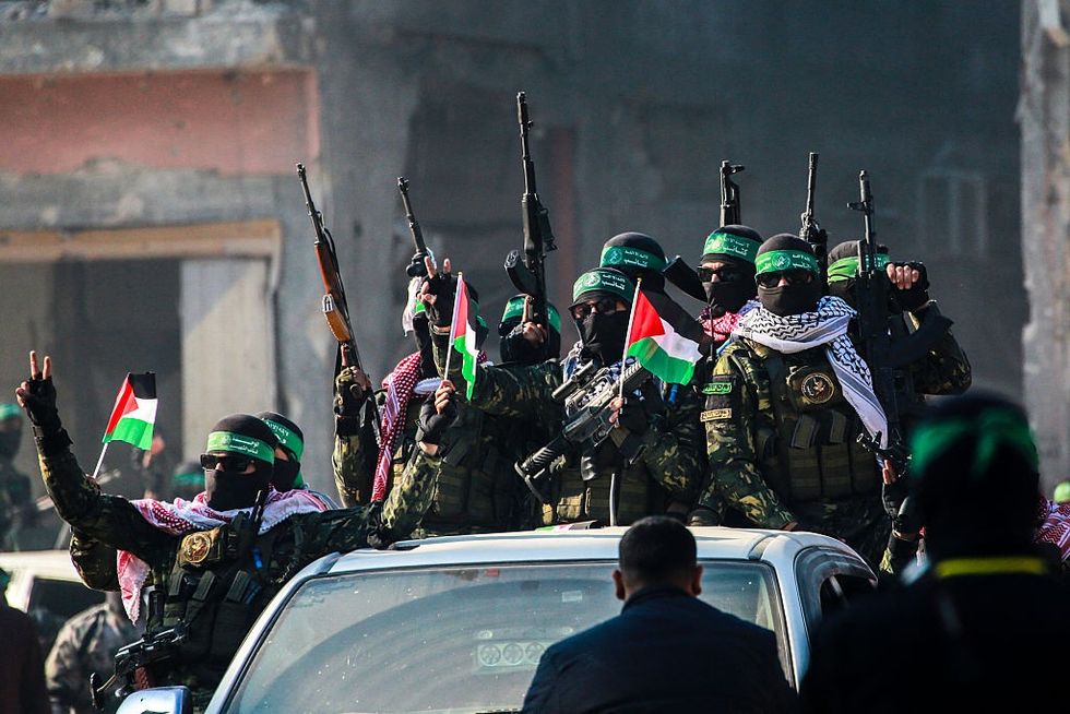 \u200bHamas militants arrive in an area before an Israeli hostage swap