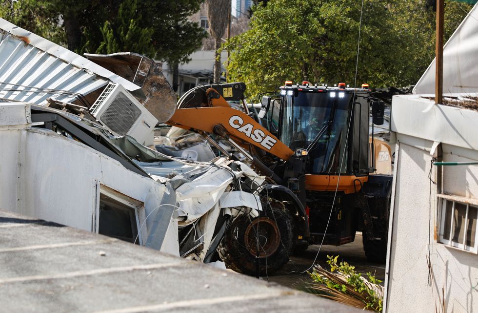 \u200bHeavy machinery operates as Israeli forces dismantle the Jerusalem headquarters of the United Nations Relief and Works Agency