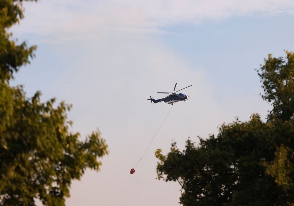 \u200bHelicopters and planes have been seen dropping water on the flames