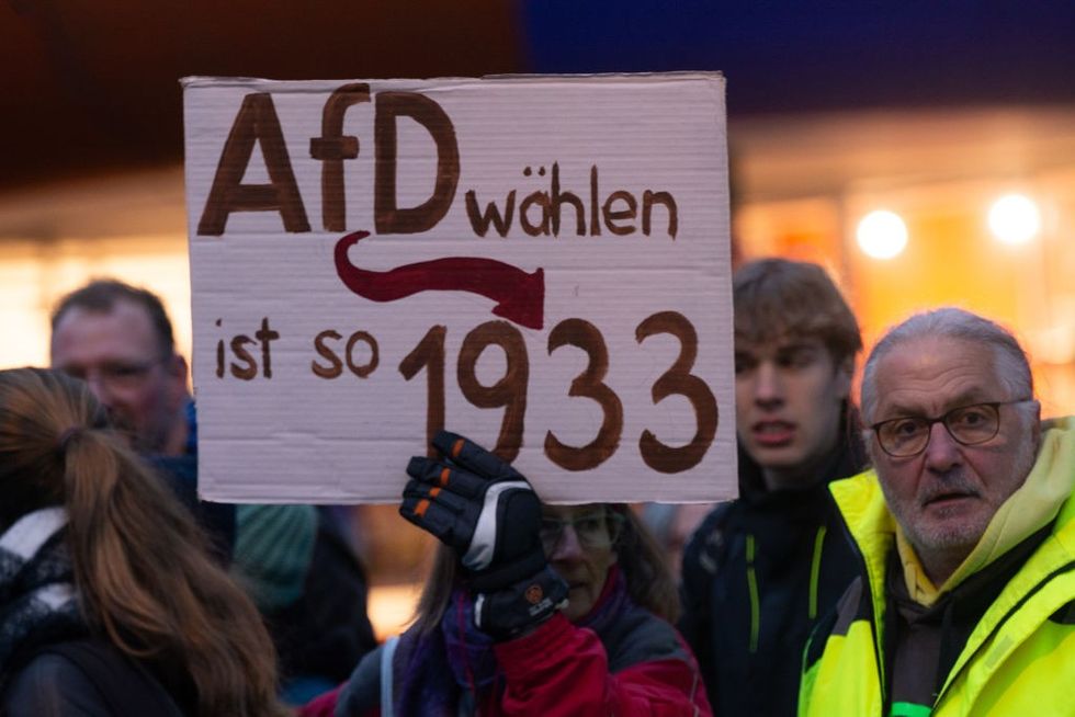 \u200bHundreds of protesters hold banners and signs against AFD in front of the Chorweiler Community Center,