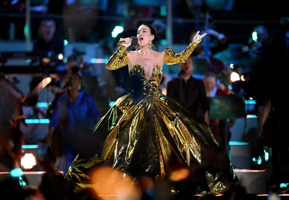 \u200bKaty Perry in a gold dress performs Firework on stage during the Coronation Concert for King Charles III