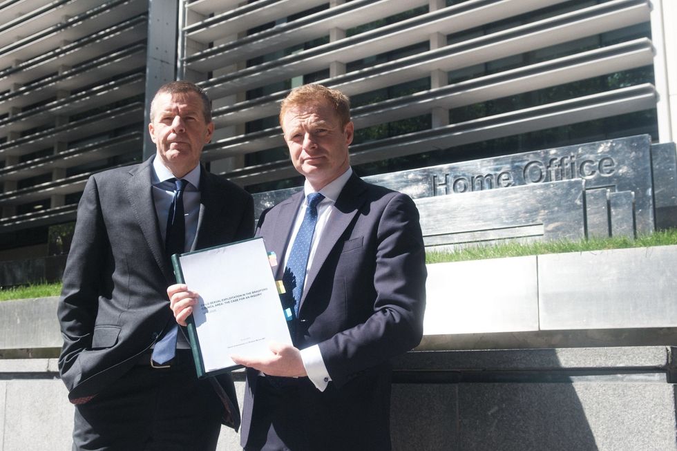 \u200bKeighley and Ilkley MP Robbie Moore and solicitor David Greenwood hand the dossier to the Home Office