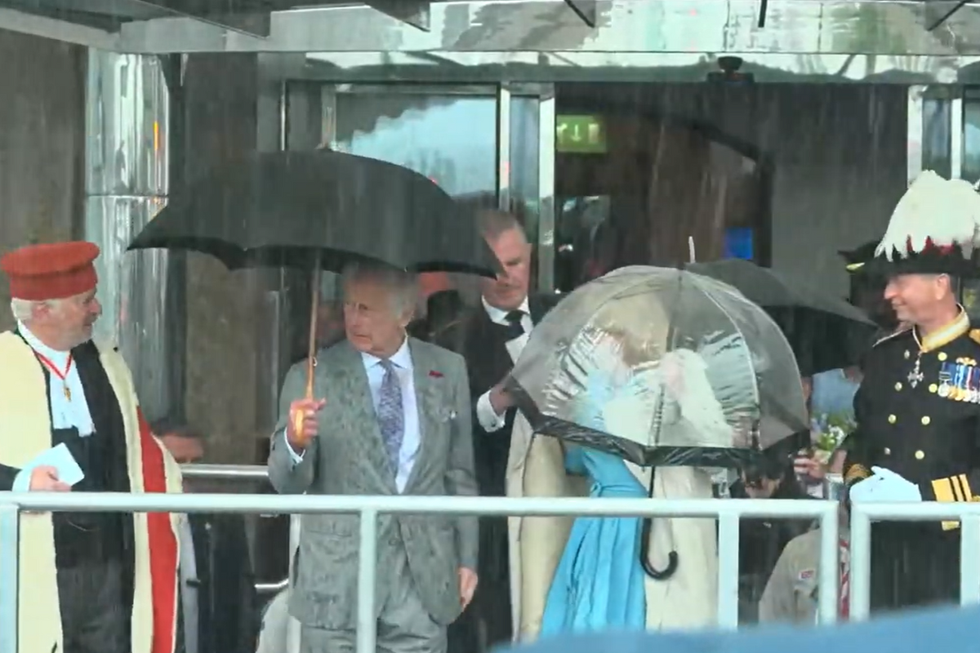 \u200bKing Charles and Queen Camilla in the rain