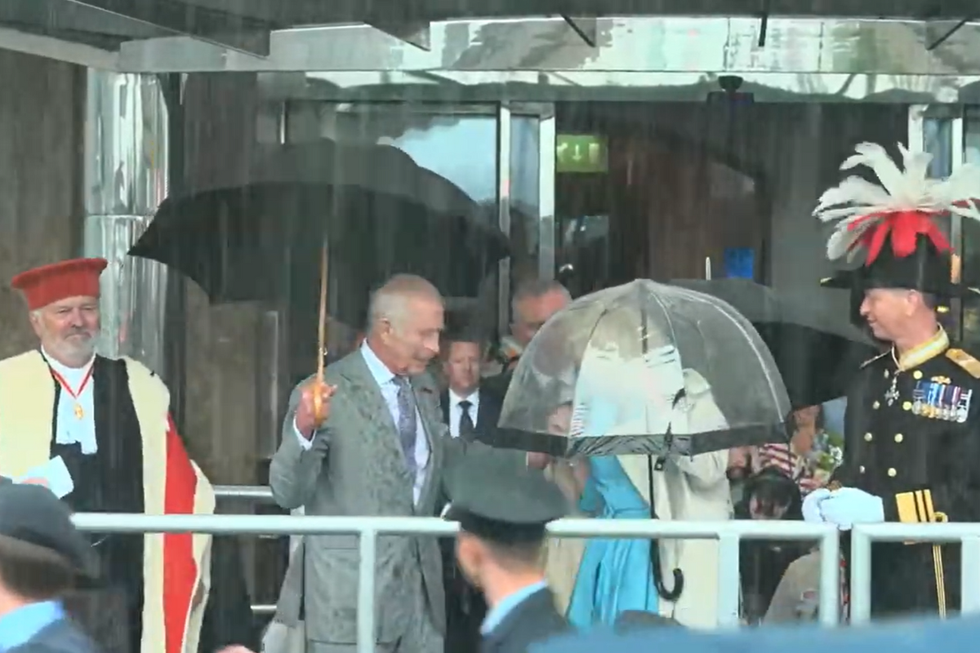 \u200bKing Charles helping Queen Camilla