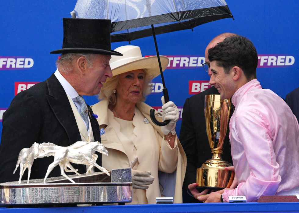 \u200bKing Charles III and Queen Camilla present the Epsom Derby Trophy to champion jockey Ronan Whelan
