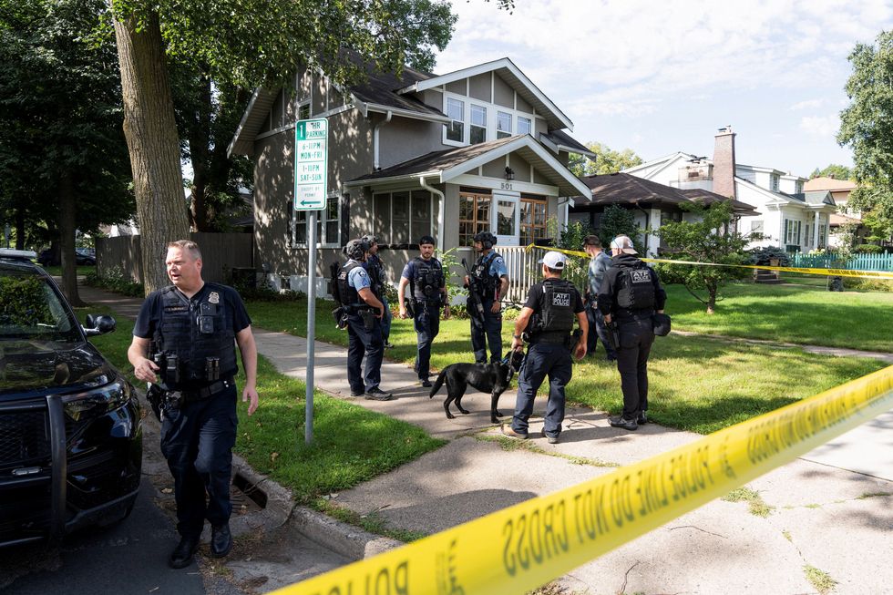 u200bLaw enforcement use K-9 dogs to search a nearby neighborhood, after a shooting at Annunciation Church
