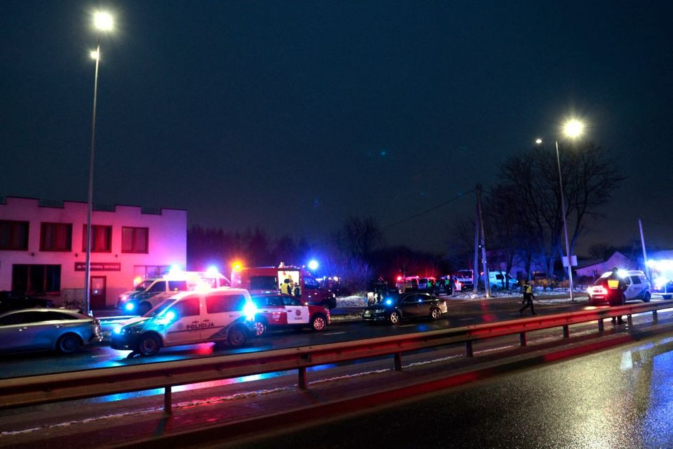 \u200bLithuanian law enforcement officers work at the crash site of a cargo plane near the Vilnius International Airport