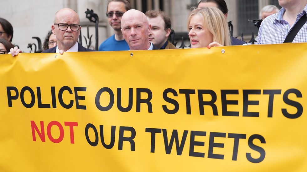 \u200bLucy Connolly's husband Ray (centre) with supporters outside the Court of Appeal at the Royal Courts of Justice in London in May