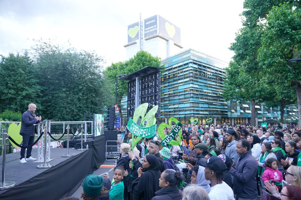 \u200bMarcio Gomes of Grenfell United speaks on stage following a silent walk near Grenfell Tower