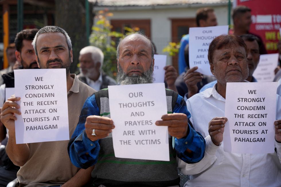 \u200bMembers from All Kashmir Tourist Taxi Transporters Welfare Federation hold placards during a sit-in to condemn the attacks