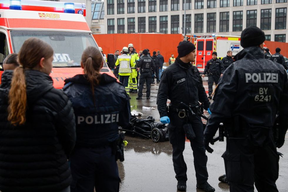 \u200bMembers of the emergency services work at the scene where a car drove into a crowd in the southern German city of Munich