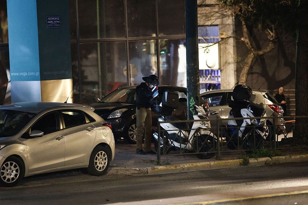 \u200bMembers of the Greek police's counter-terrorism unit investigate the area outside the Hellenic Train offices