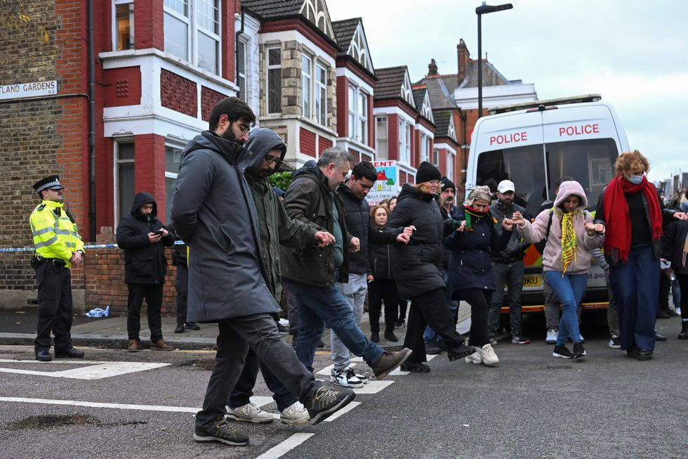 \u200bMembers of the Kurdish community perform a dance near a Kurdish community centre as a protest earlier today