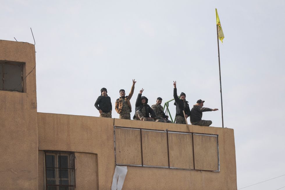 \u200bMembers of the Kurdish-led Syrian Democratic Forces (SDF) gesture in Deir al-Zor, after U.S.-backed alliance led by Syrian Kurdish fighters captured Deir el-Zor