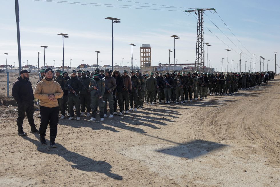\u200bMembers of the Syrian government security forces gather after they took control of al-Hol camp