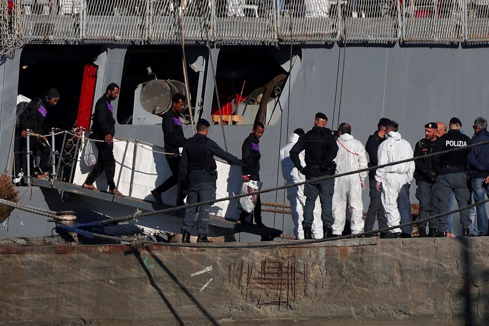 \u200bMigrants disembark from the Italian navy ship Libra carrying migrants that arrived in Albania as part of a deal with Italy